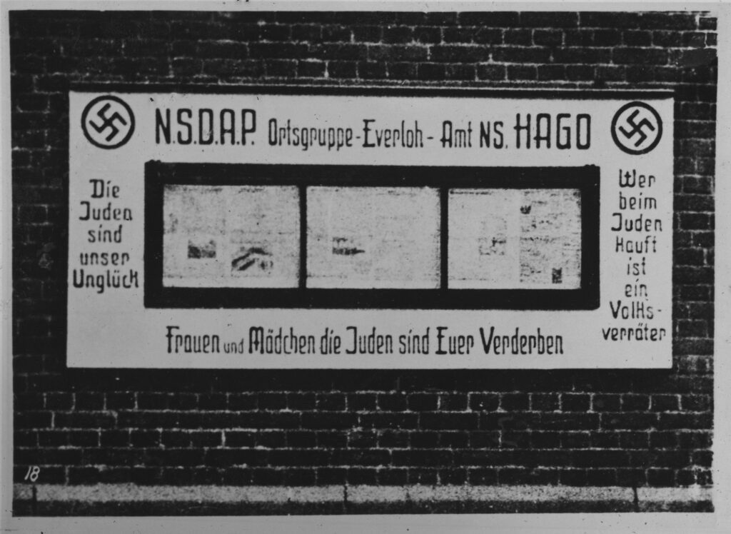 N.S.D.A.P billboard on a brick wall.