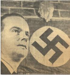 Head shot of a man looking into the distance with a Nazi flag on the wall behind him.
