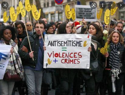 A group of people protesting against antisemitism holding banners.